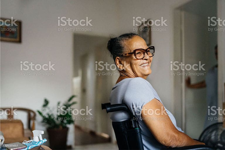 Happy elderly woman in the wheelchair Wheelchair woman smiling in the room.